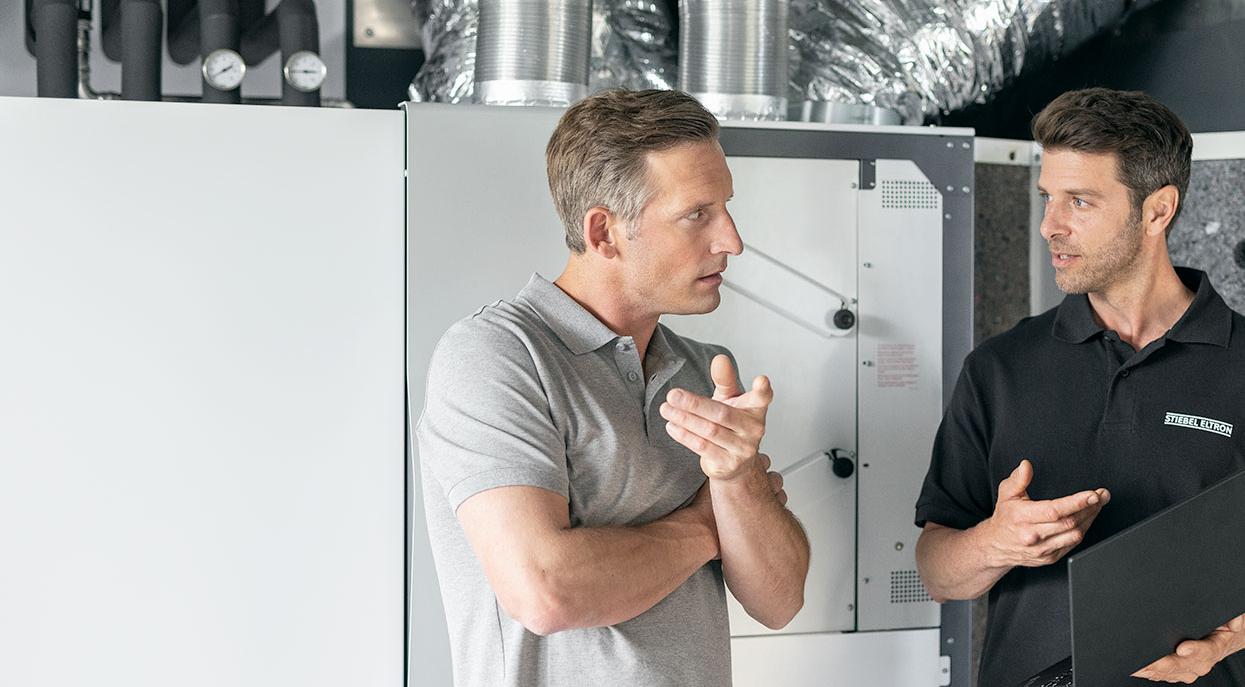 A stiebel eltron employee helping someone with a question